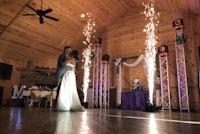 a bride and groom dance in front of sparklers