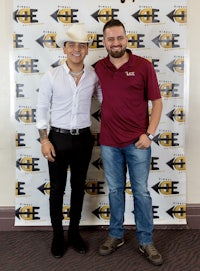 two men standing next to each other at an event