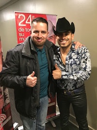 two men in cowboy hats standing next to each other